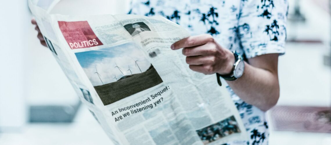 man reading about climate and environment in the newspaper